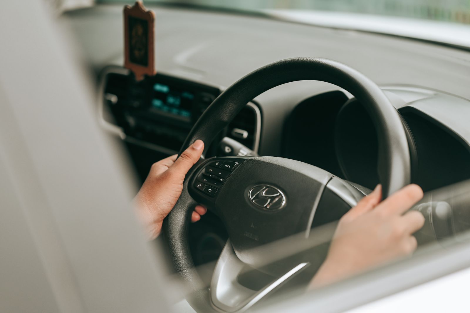 Hands on a steering wheel while driving